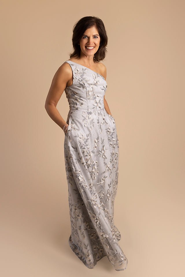 One Shoulder Floral Metallic Gown with Pleated Bodice, Silver The Queen's Lace One Shoulder Floral Metallic Gown with Pleated Bodice, Silver The Queen's Lace