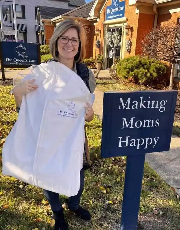 woman standing next to a sign that says Making Moms Happy
