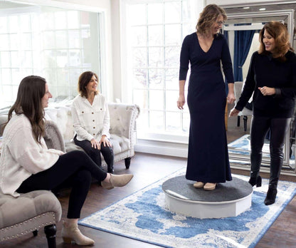 mother of the bride trying on a long, navy dress